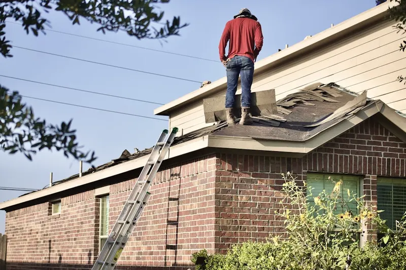 Professional roofer working on a residential roof in South Wethersfield